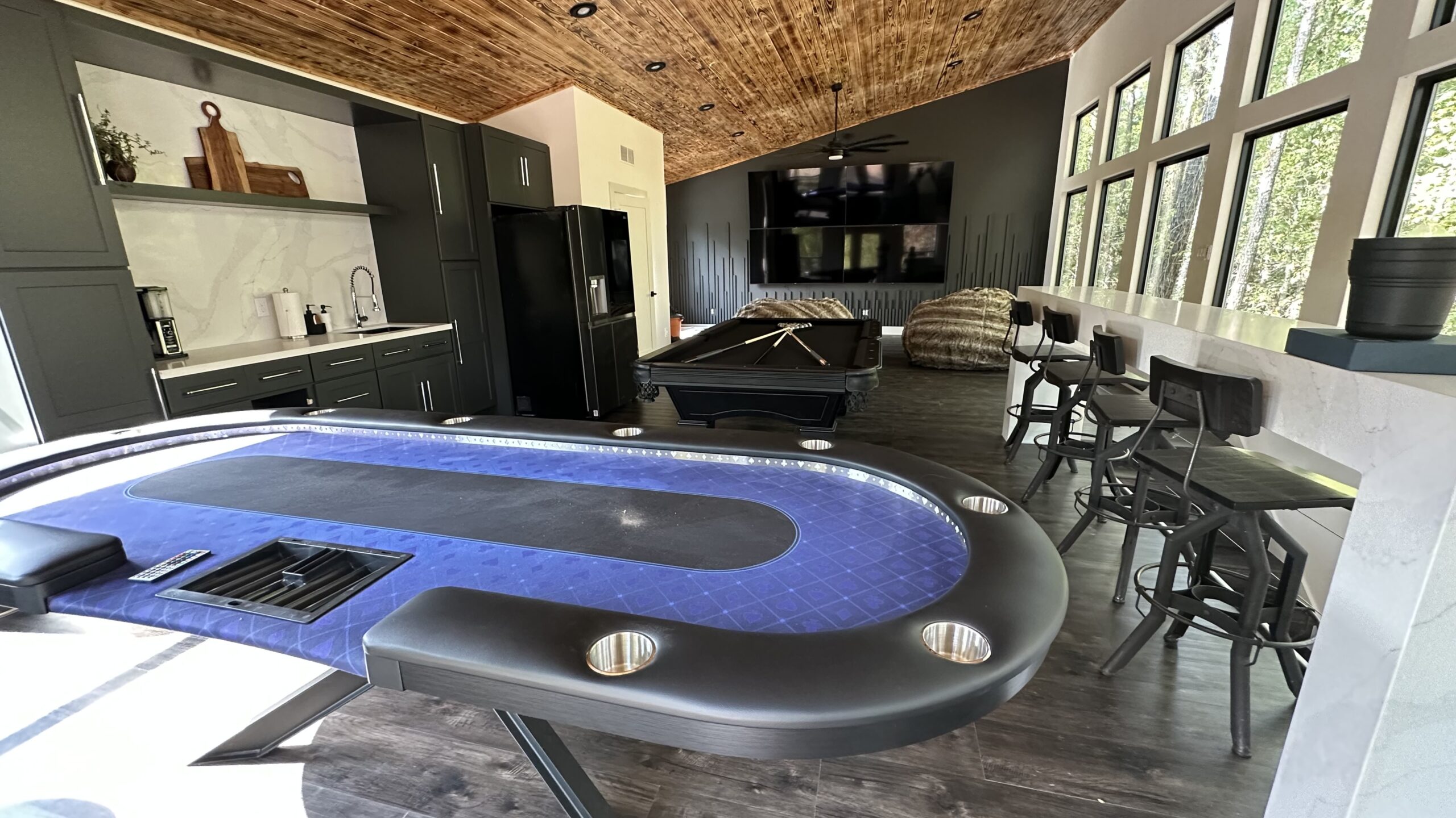 A room with a pool table and a television.